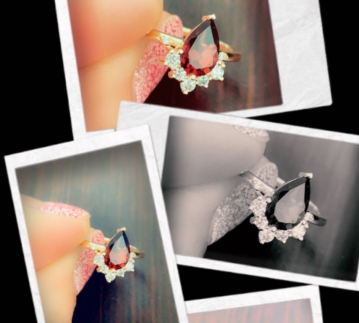 Custom diamond ring being held between thumb and pointer finger