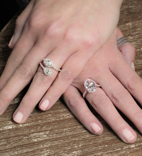 two hands each wearing a custom ring